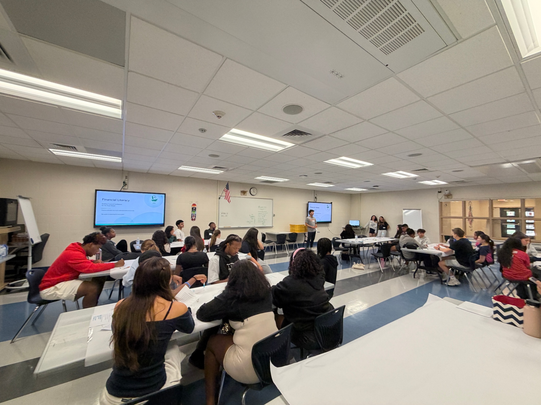A full classroom of students at the start of an intro to finance workshop.